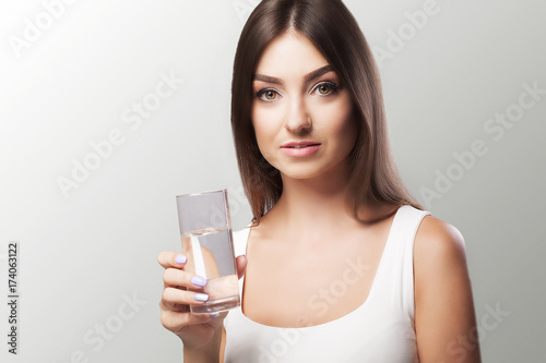 Health, Beauty, Diet. Portrait of a happy smiling young woman who drank water from refreshing water in the morning. Healthy Drinks Healthy Nutrition. Healthy Lifestyle. © Maksymiv Iurii