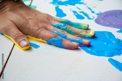 Hand make a trace colorful symbol on white paper background