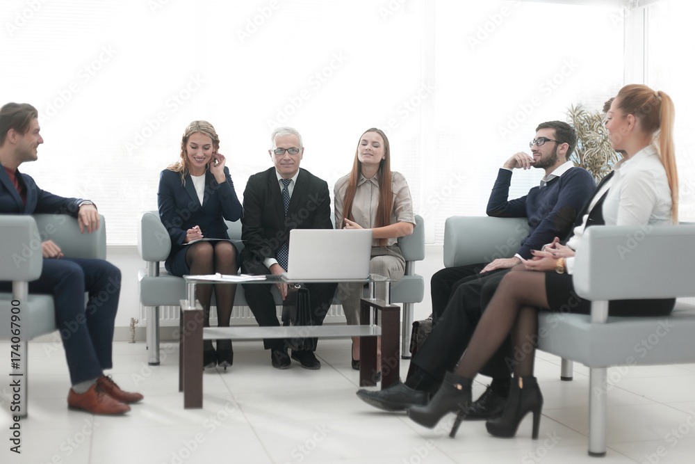 senior businessman and business team sitting in the lobby of the modern office. senior businessman and business team sitting in the lobby of the modern office.