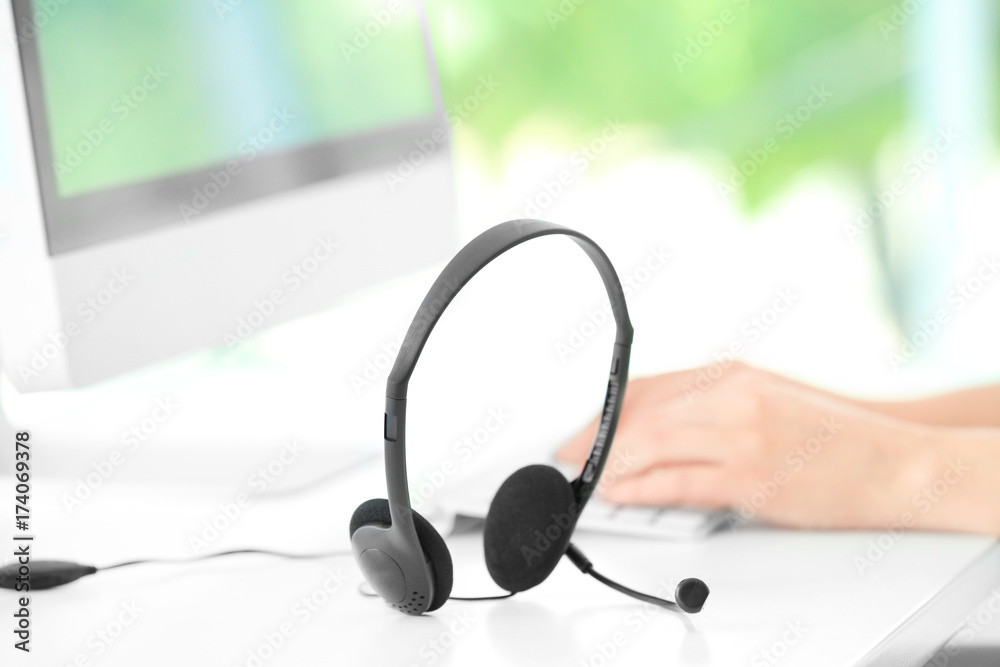 Headset on table of technical support agent Headset on table of technical support agent
