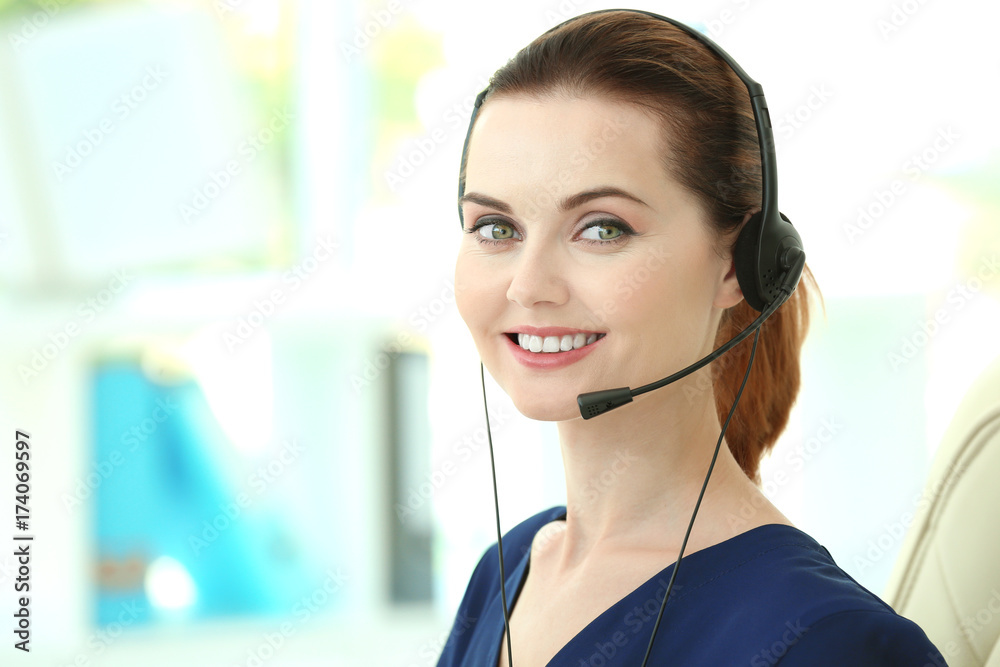 Young female technical support dispatcher working in office Young female technical support dispatcher working in office
