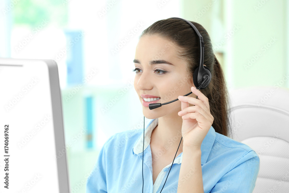 Young female technical support dispatcher working in office