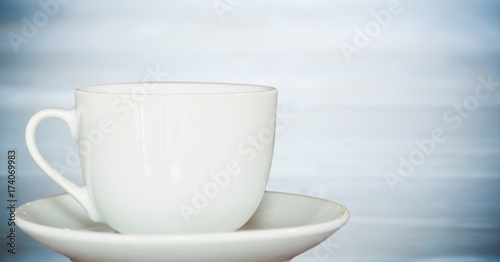 White cup against blurry blue wood panel