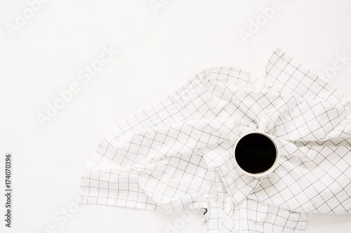 Coffee mug on cloth. Flat lay minimal concept.