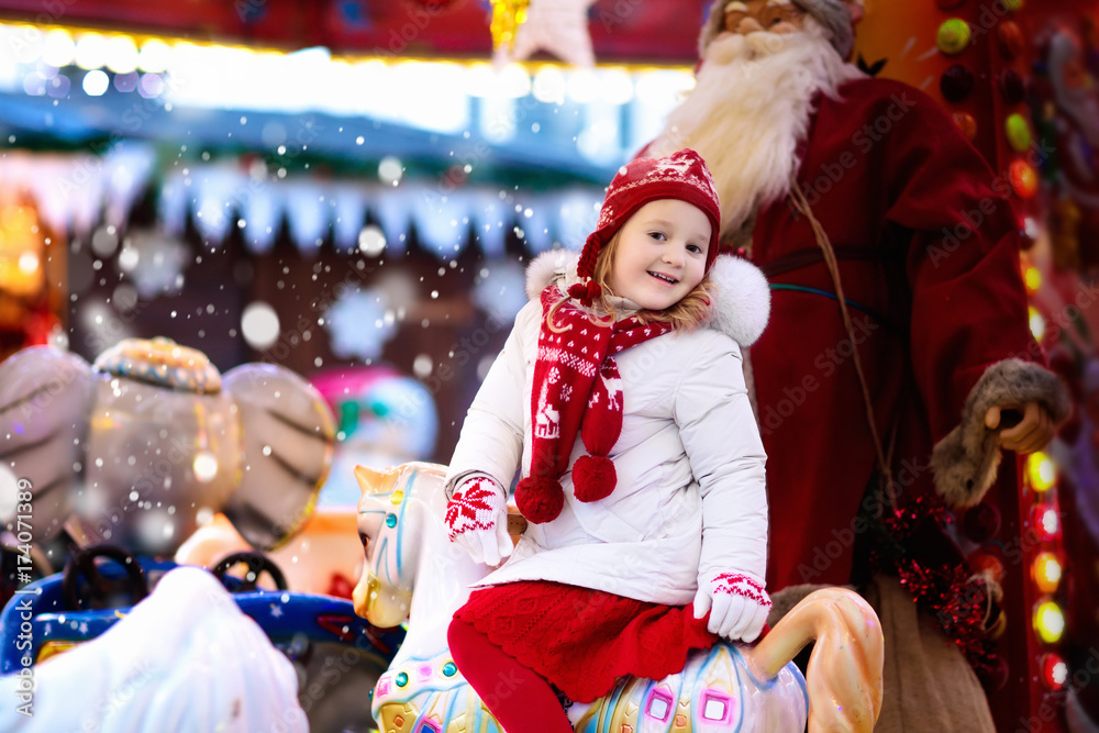 Child on Christmas fair. Kid riding Xmas carousel Child on Christmas fair. Kid riding Xmas carousel