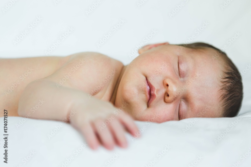 Newborn Baby Girl Sleeping on Soft White Newborn Baby Girl Sleeping on Soft White