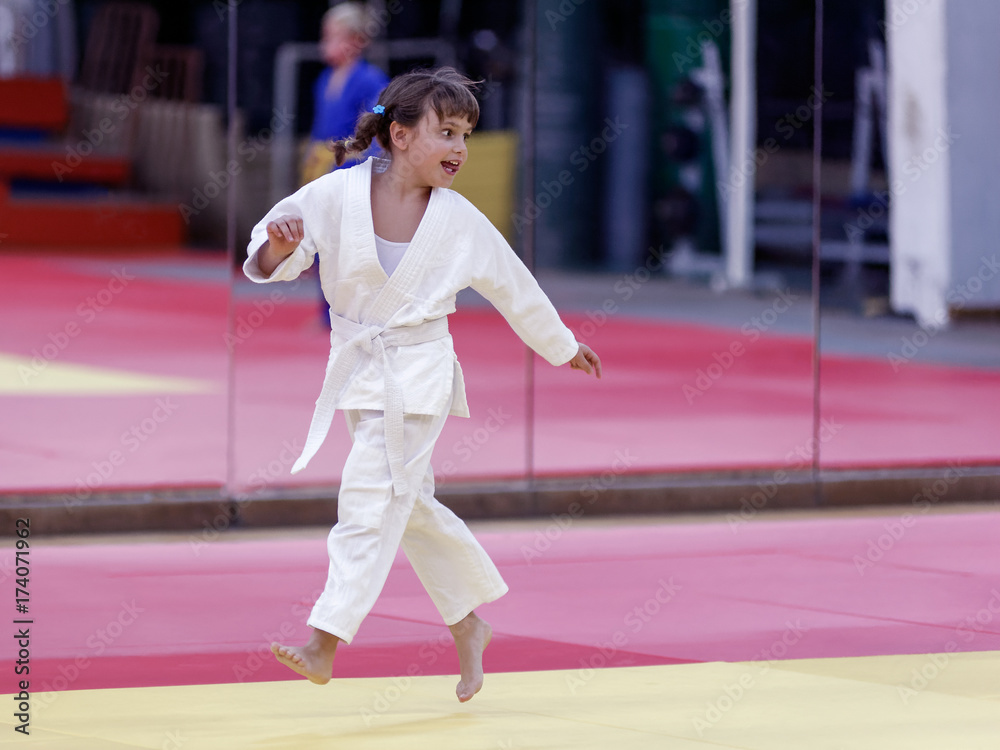 A cute little girl at a judo training