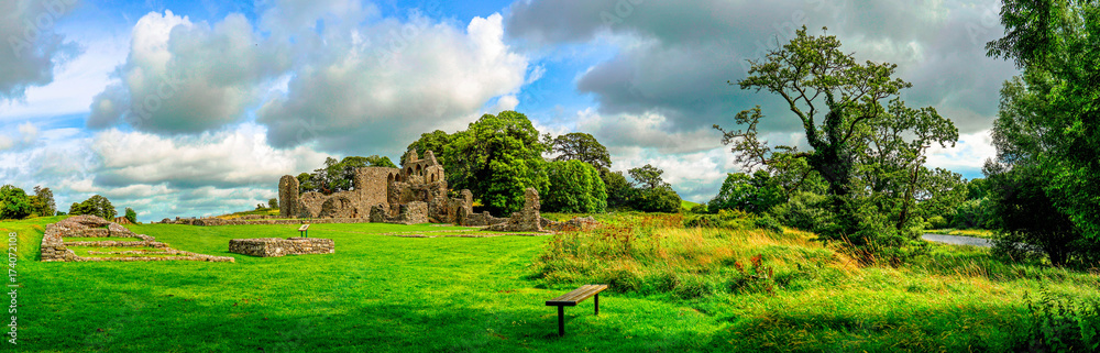 Landscape of Inch Abbey in Northern Ireland. Monastery ruins in Downpatrick. Co. Down. Travel by car in summer. Landscape of Inch Abbey in Northern Ireland. Monastery ruins in Downpatrick. Co. Down. Travel by car in summer.