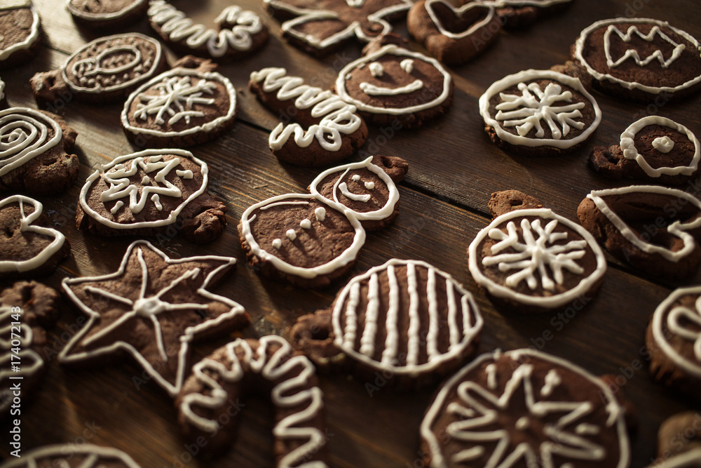 Traditional homemade Christmas ginger and chocolate cookies decorated with white sugar painting Traditional homemade Christmas ginger and chocolate cookies decorated with white sugar painting