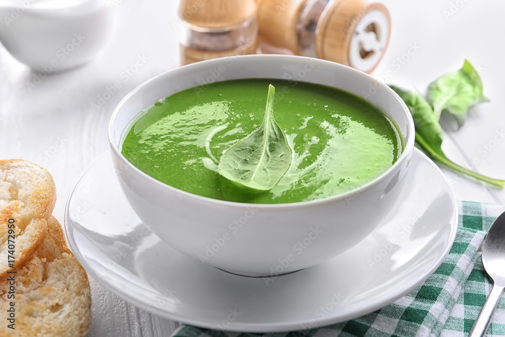 Bowl with tasty spinach soup on table Bowl with tasty spinach soup on table