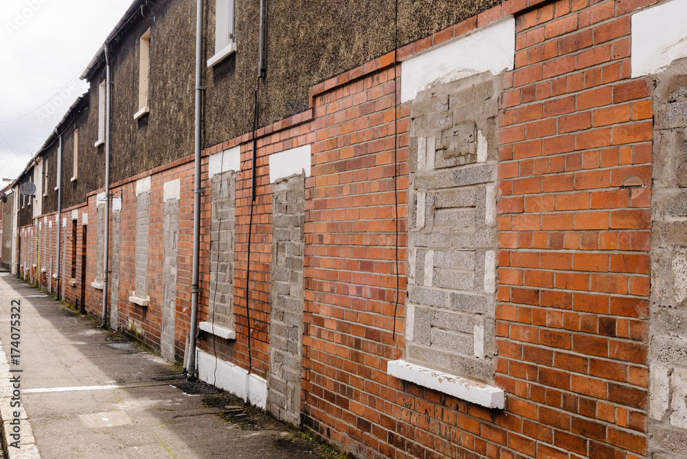 Bricked up and abandoned town houses in a run-down city street