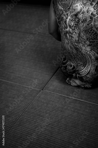 Japanese man with tattooed back formally sitting in seiza style photo