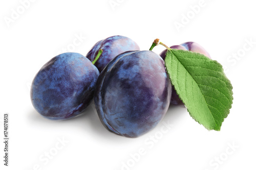 Ripe plums on white background