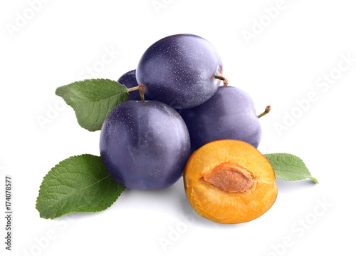 Ripe plums on white background