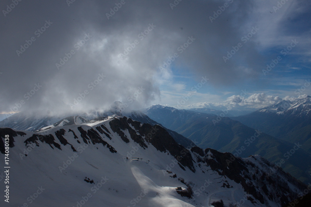 Peaks of the Caucasian mountains in the clouds with a height of two thousand three hundred twenty feet, Sochi, Russia.