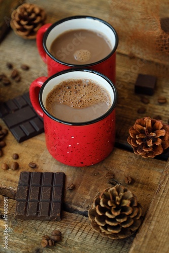 Delicious cocoa and chocolate on wooden table