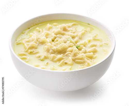 Bowl of noodle soup with cheese and herbs