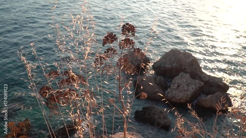 waves in the sea in the afternoon hitting the rocks on the shore