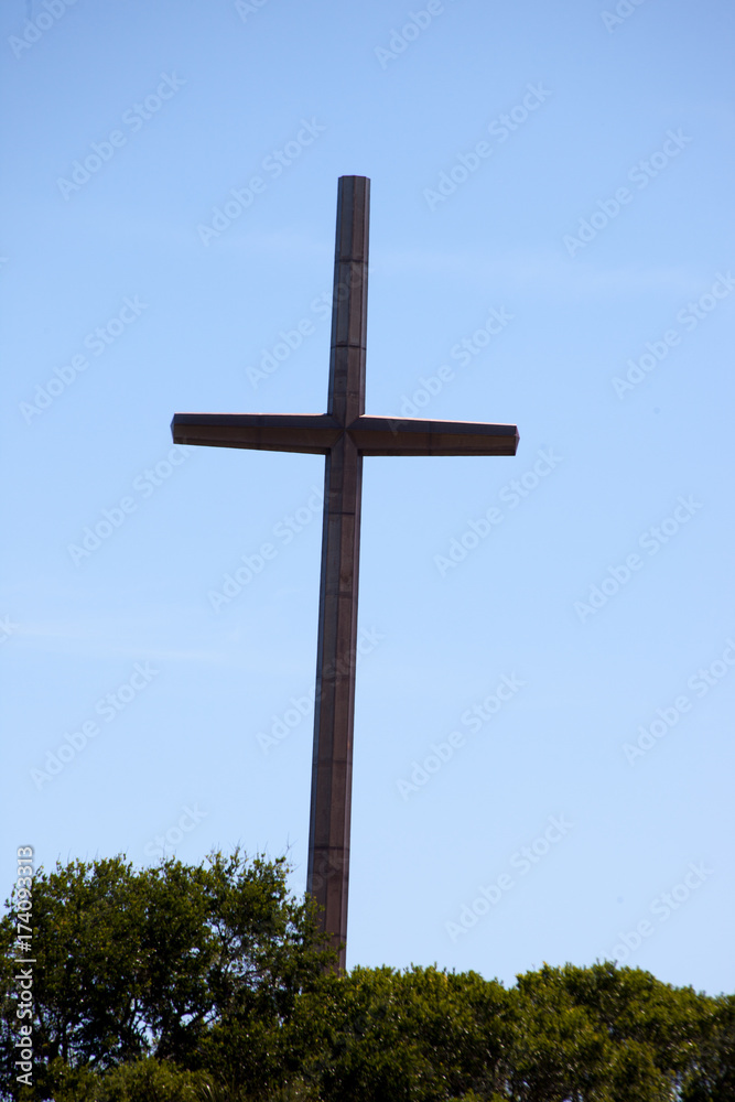 Large metal cross above the trees