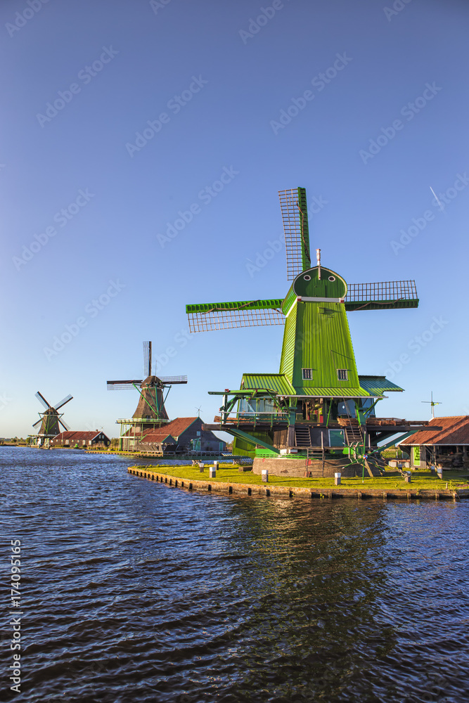Travelling Ideas. View of Traditional Wooden Dutch Windmills at the Zaan River in Zaanse Schans, Holland, The Netherlands