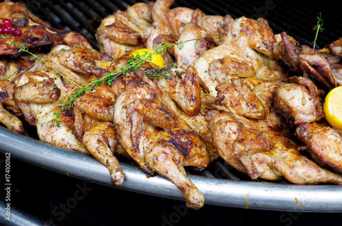 Cooking chicken on a barbecue grill.