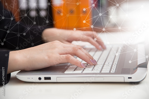 Close-up hands of business woman working and typing on laptop keyboard