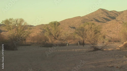 People On Horseback In the Desert On A Clear Summer Day