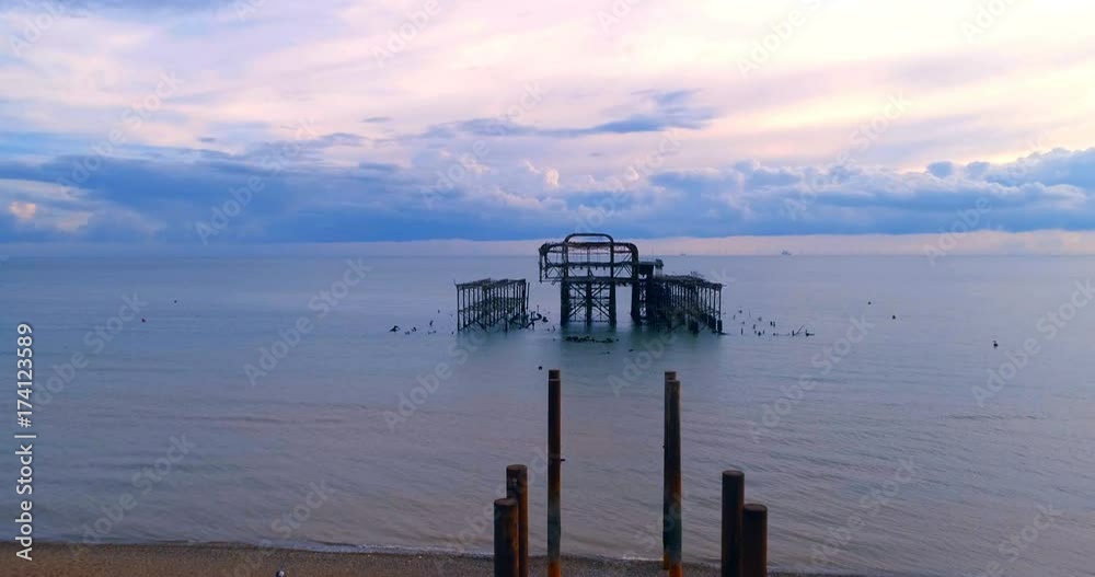 Aerial pull out view of the destroyed West Pier in Brighton at sunset Aerial pull out view of the destroyed West Pier in Brighton at sunset