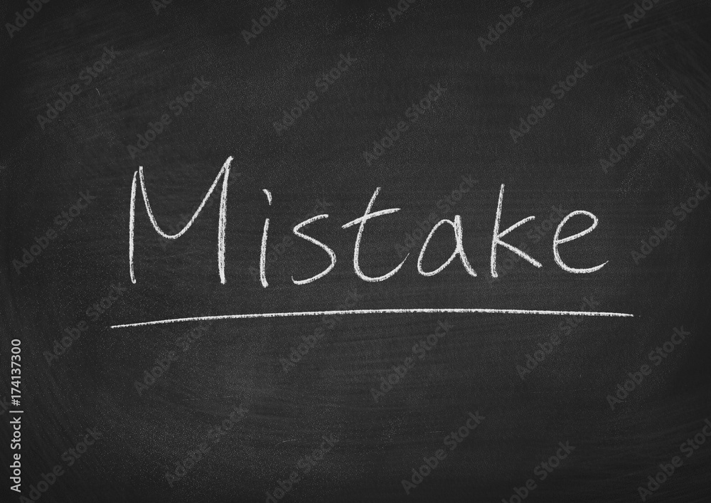 Obraz premium mistake concept word on a blackboard background