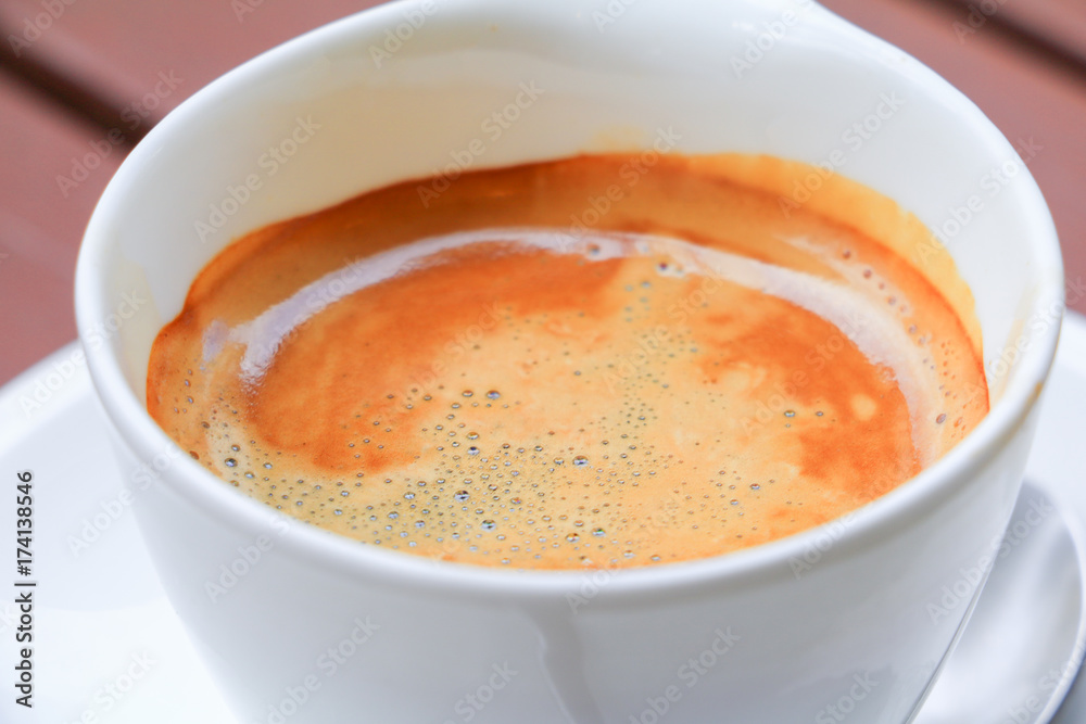 coffee espresso in white cup close up on wood background coffee espresso in white cup close up on wood background