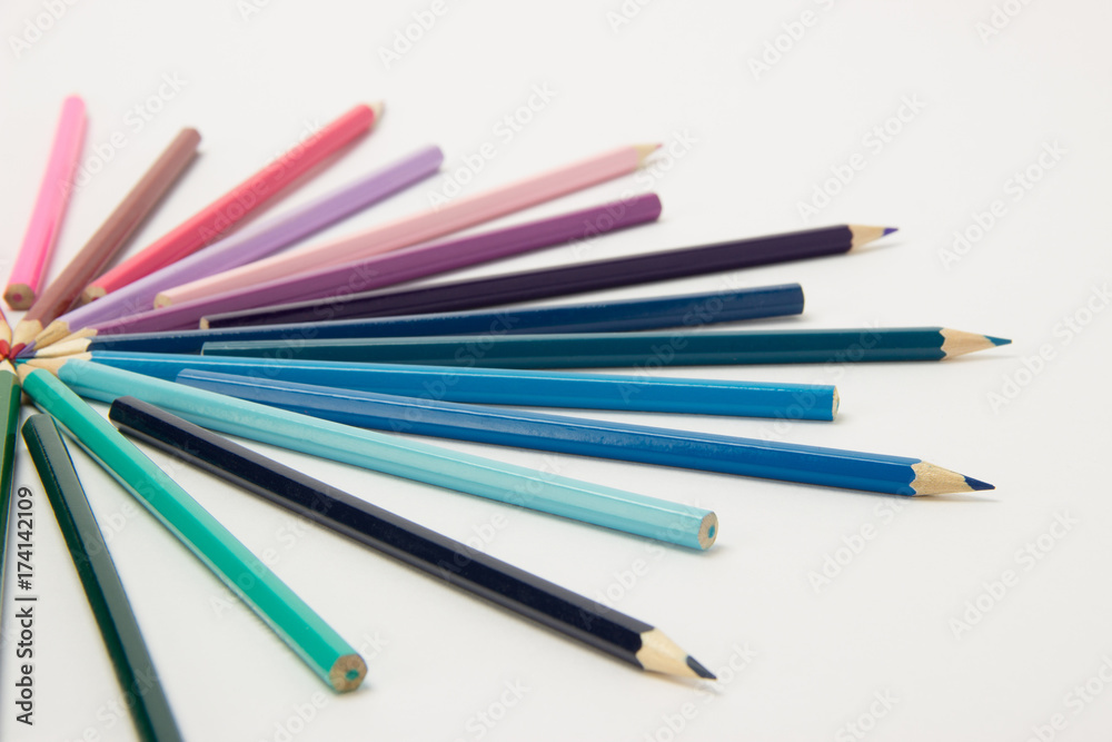 A group of pencils folded in rainbow colors in a circle on a white background A group of pencils folded in rainbow colors in a circle on a white background