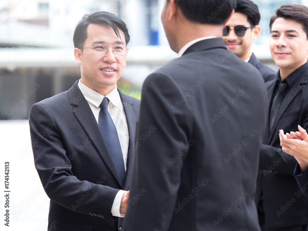 Business congratulations concept, middle age of asian businessman shaking hands with boss, manager for successful in business Business congratulations concept, middle age of asian businessman shaking hands with boss, manager for successful in business