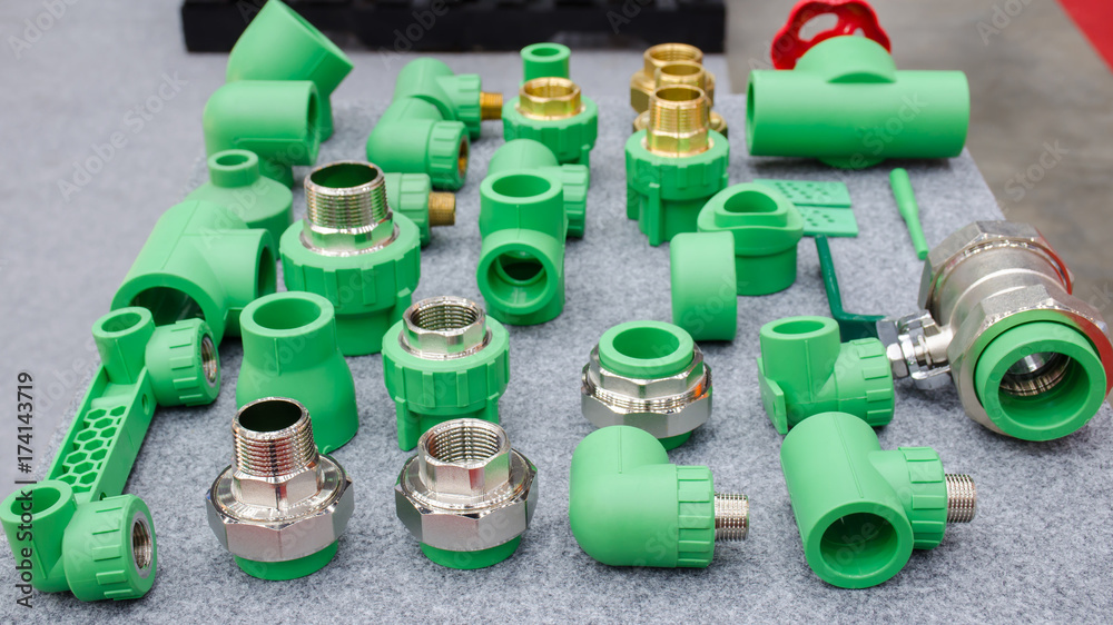 PPR water pipe fittings,Plumbing connection fittings for plastic pipes. Orderly arranged in neat rows. Abstract industrial background.
