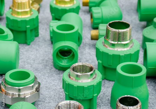 PPR water pipe fittings,Plumbing connection fittings for plastic pipes. Orderly arranged in neat rows. Abstract industrial background.