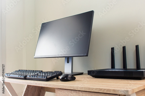 Office table with wifi router and computer and supplies