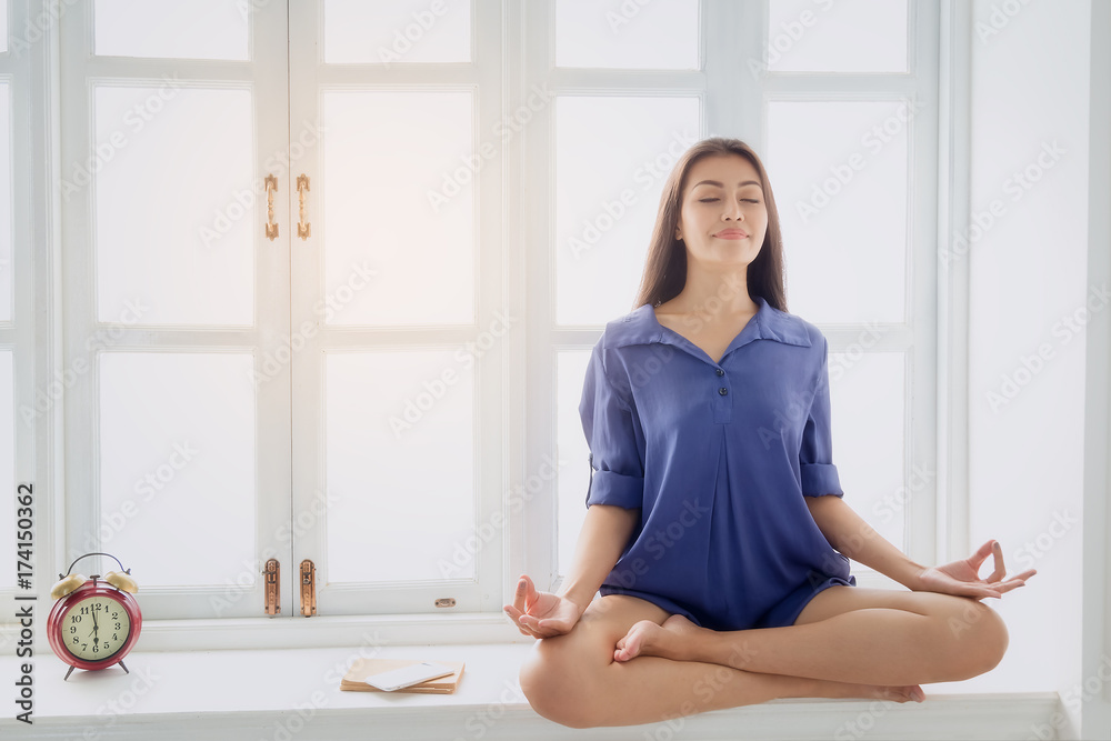 Young woman exercises with yoga in the morning after waking up. Health care concept Young woman exercises with yoga in the morning after waking up. Health care concept