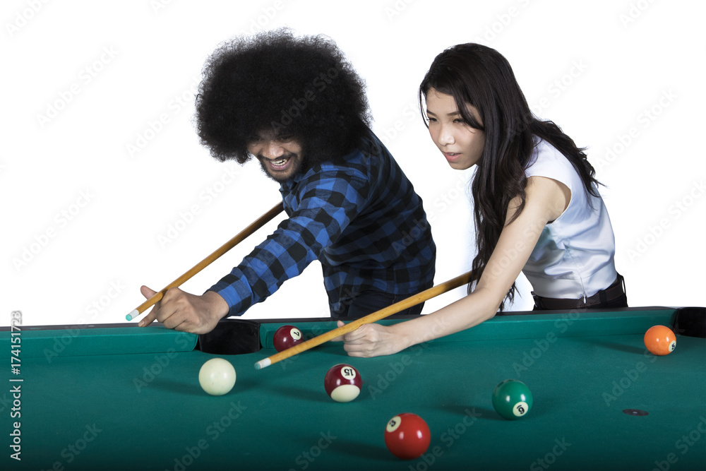 Fototapeta premium Two multiracial people playing billiards