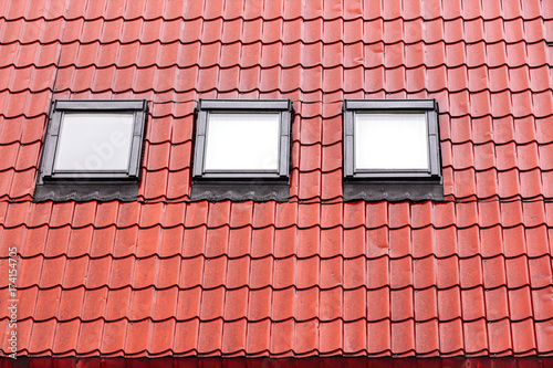 red tiled roof with skylights wet after heavy rain