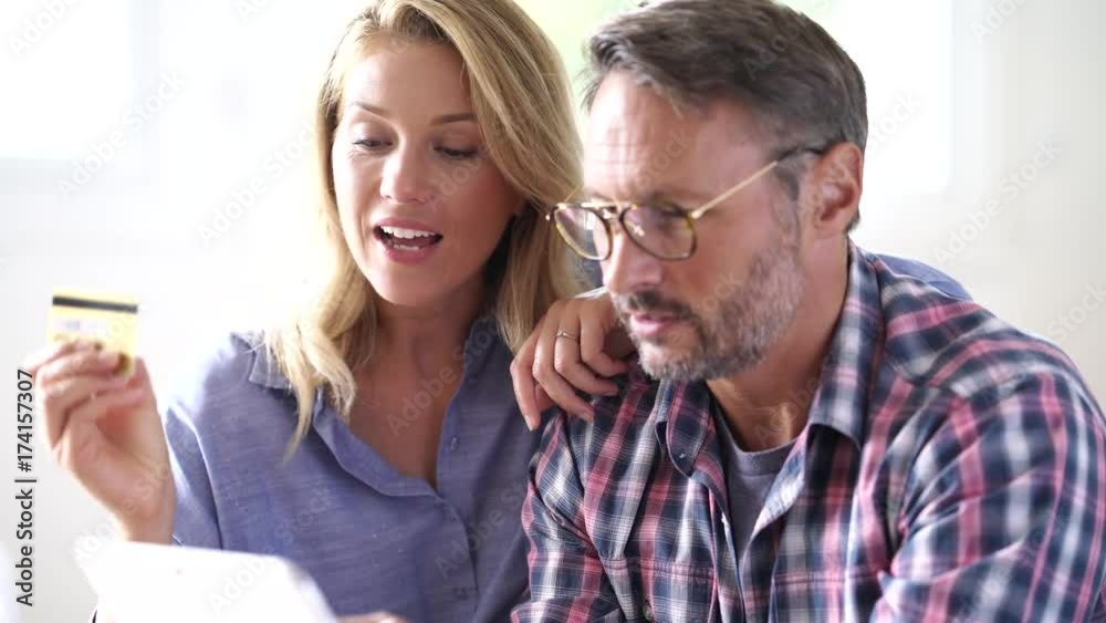 Mature couple buying on internet, online shopping Mature couple buying on internet, online shopping