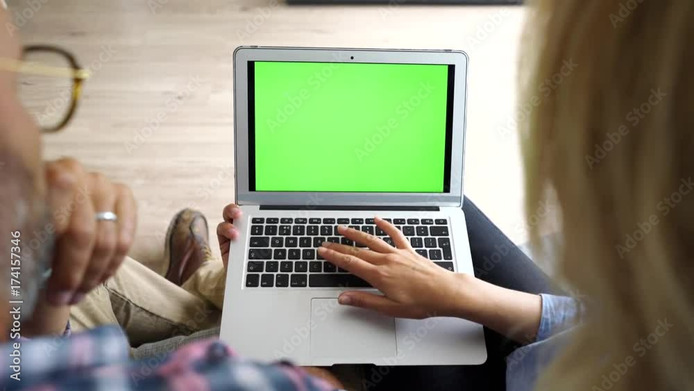 Upper view of couple in sofa using laptop computer Upper view of couple in sofa using laptop computer