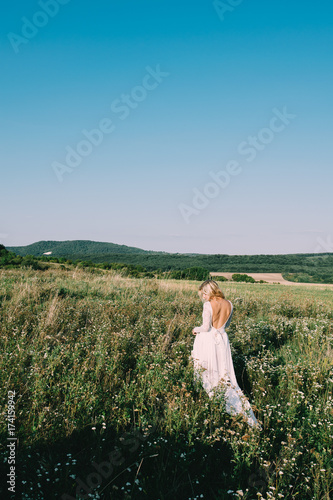 Beautiful bride outdoors in white wedding dress