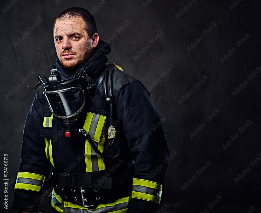 Naklejka premium Studio portrait of a male dressed in a firefighter uniform.
