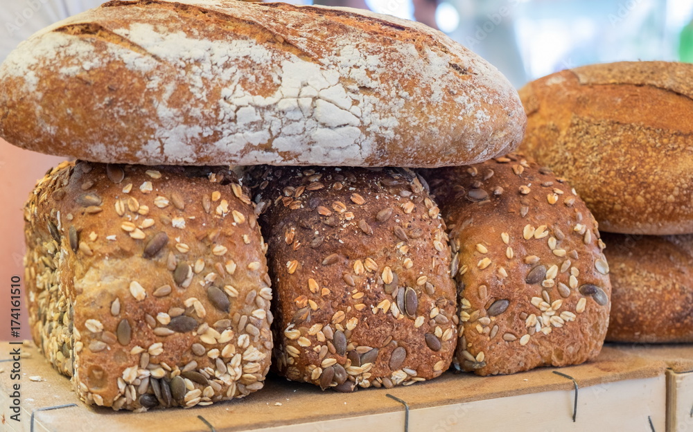 Fresh brown bread with sesame and sunflower seeds for sale at local farmers market