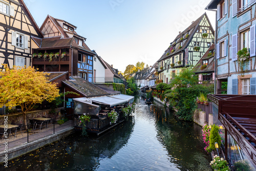 Fototapeta Naklejka Na Ścianę i Meble -  Beautiful view of the historic town of Colmar, also known as Little Venice, boat ride along traditional colorful houses on idyllic river Lauch in summer, Colmar, Alsace, France