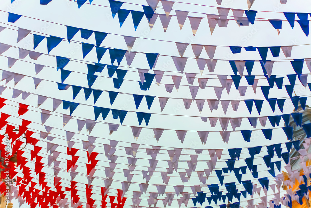 Fototapeta premium colored flags festive on a city street