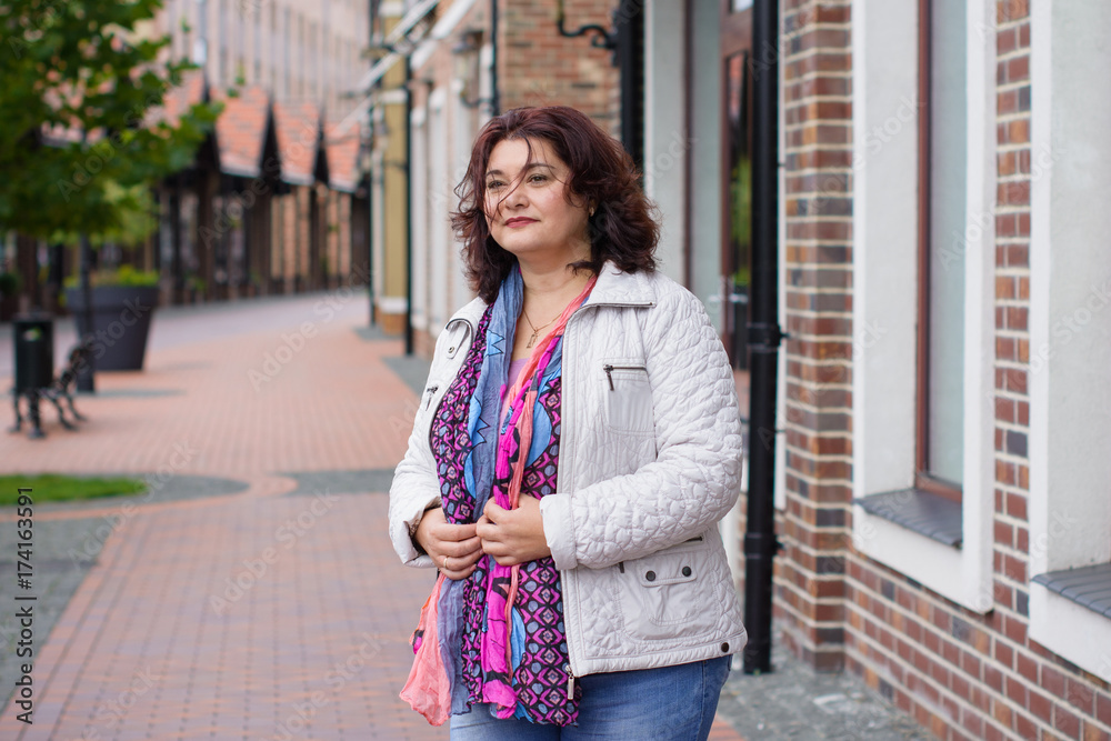 American nice and simple plus size tourist woman wear in jacket, scarf and jeans walk on European streets and shops American nice and simple plus size tourist woman wear in jacket, scarf and jeans walk on European streets and shops