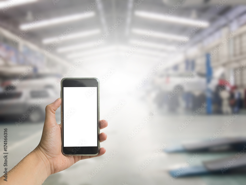 Hand holding phone with car service background Hand holding phone with car service background