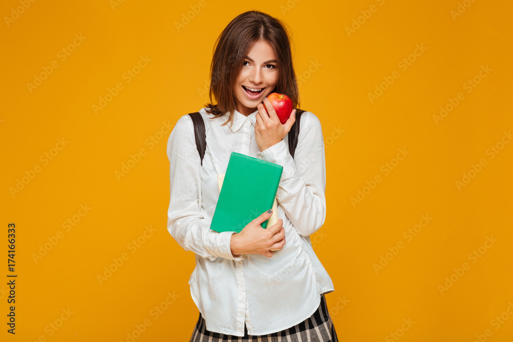 Portrait of a pretty schoolgirl holding books Portrait of a pretty schoolgirl holding books
