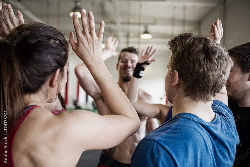 People Giving High Five To Each Other In Gymnasium People Giving High Five To Each Other In Gymnasium