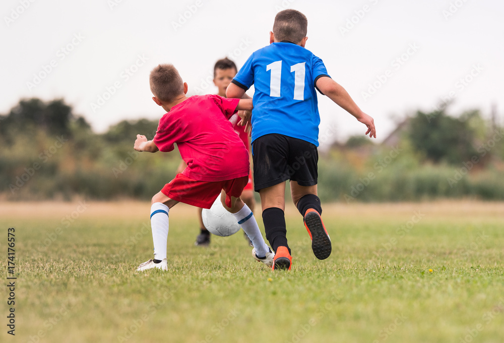 Kids soccer football - children players match on soccer field Kids soccer football - children players match on soccer field